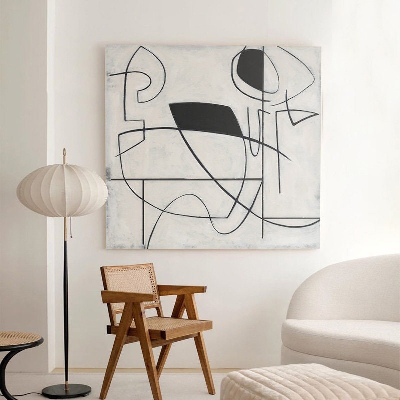 Grey and white hand-painted abstract canvas art in a modern living room